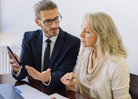 Professional business discussion between a consultant and client in an office setting.